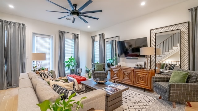 living room featuring ceiling fan and light wood-type flooring