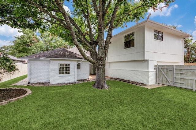 rear view of property with a lawn