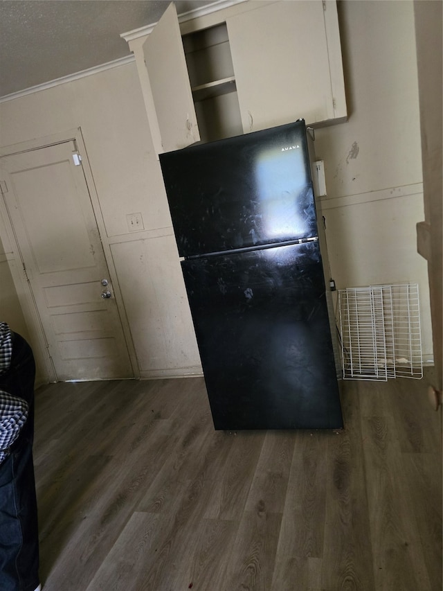 interior space with crown molding and wood-type flooring