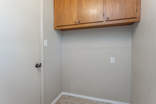 laundry area featuring light tile patterned flooring