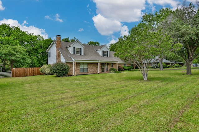 cape cod home featuring a front yard