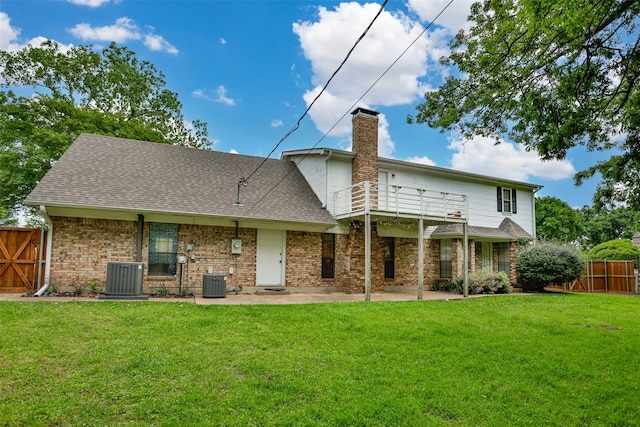 rear view of property with central AC, a lawn, and a patio area