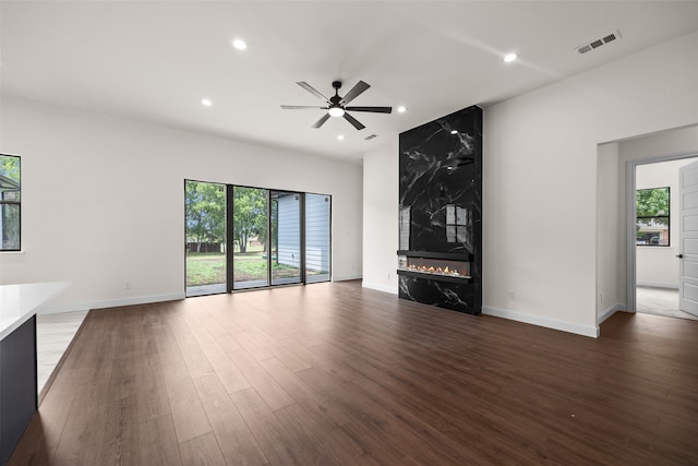 unfurnished living room with a premium fireplace, ceiling fan, and hardwood / wood-style floors