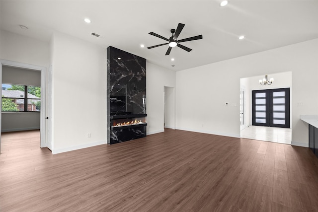 1057 Meadow Hill Dr, Lavon, TX 75166 - unfurnished living room featuring a fireplace, wood finished floors, a chandelier, a ceiling fan, and lofted ceiling