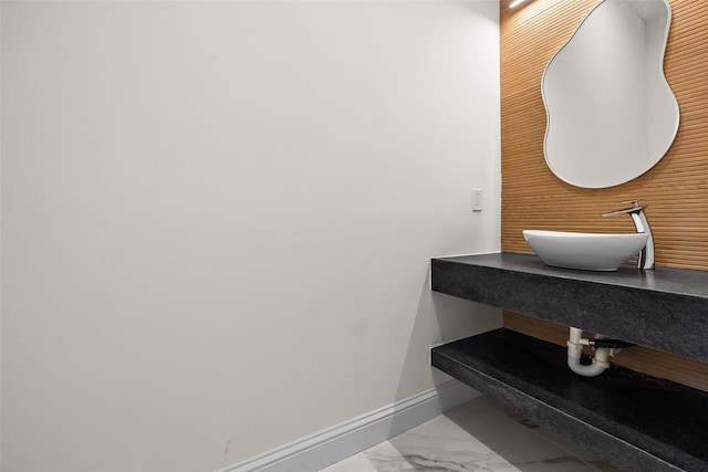 1057 Meadow Hill Dr, Lavon, TX 75166 - bathroom with a sink, marble look tiles, and baseboards