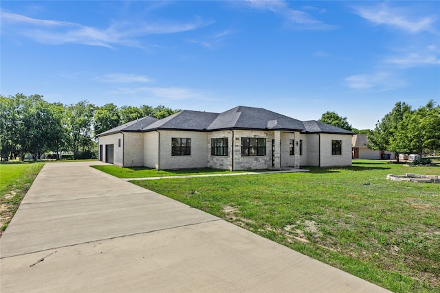 1057 Meadow Hill Dr, Lavon, TX 75166 - back of house with concrete driveway, an attached garage, and a yard
