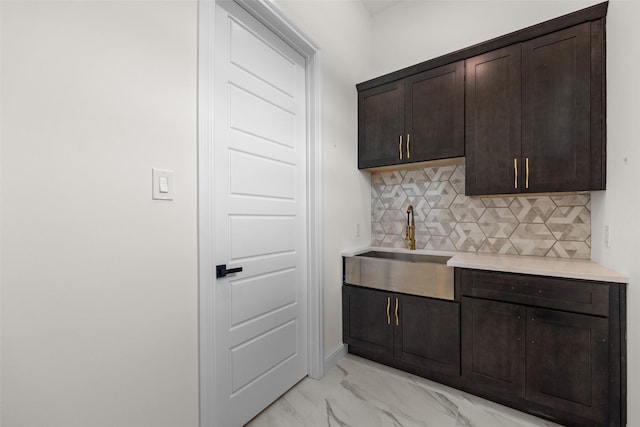 1057 Meadow Hill Dr, Lavon, TX 75166 - kitchen with dark brown cabinets, light countertops, tasteful backsplash, light marble finish flooring, and a sink
