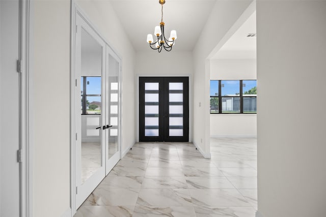 1057 Meadow Hill Dr, Lavon, TX 75166 - entrance foyer with french doors, a chandelier, light marble finish flooring, and baseboards