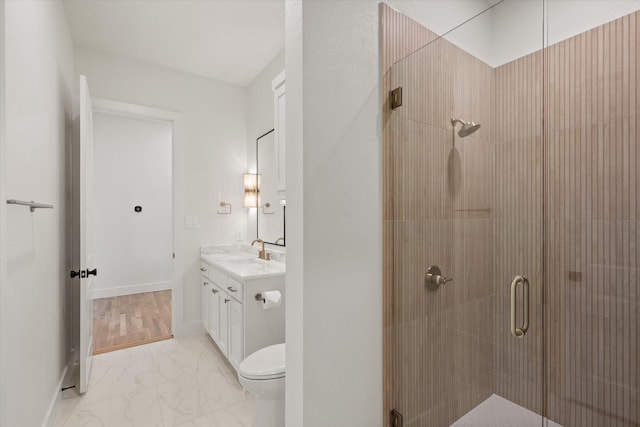 bathroom with vanity, toilet, and a shower with shower door