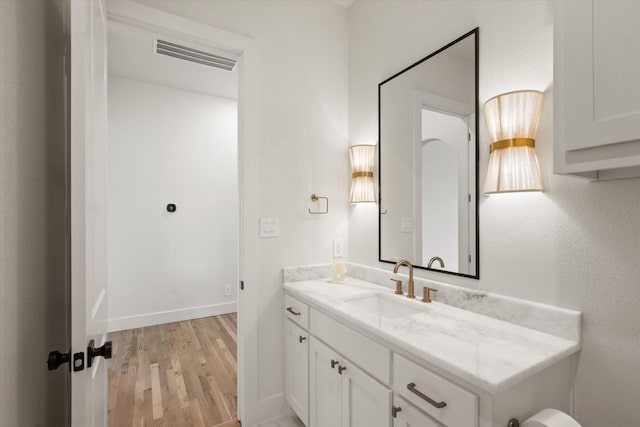 bathroom with hardwood / wood-style flooring and vanity