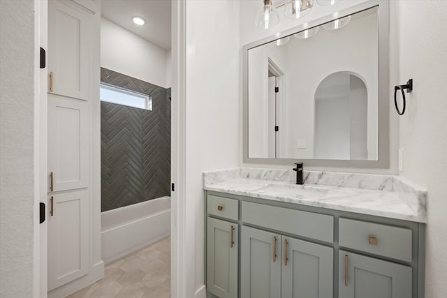 bathroom featuring tile patterned floors, vanity, and tiled shower / bath combo