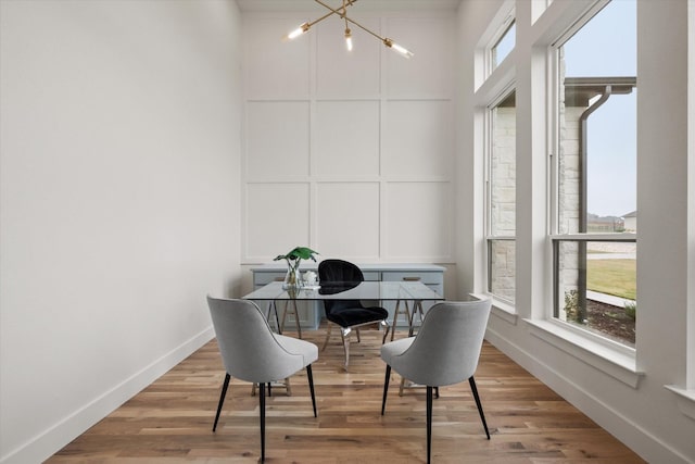 office area with an inviting chandelier and hardwood / wood-style flooring