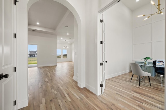 hall featuring a chandelier and light hardwood / wood-style floors