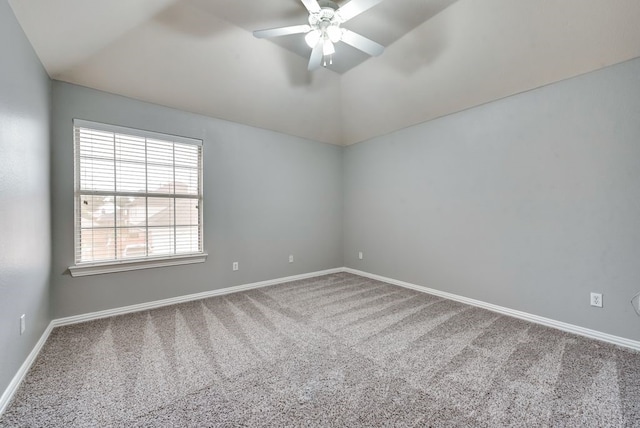 spare room with vaulted ceiling, ceiling fan, and carpet