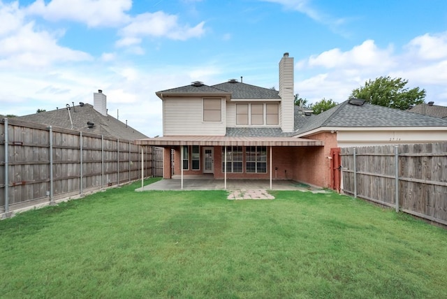 rear view of property featuring a patio area and a yard