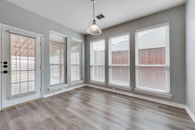 unfurnished dining area with light wood-type flooring