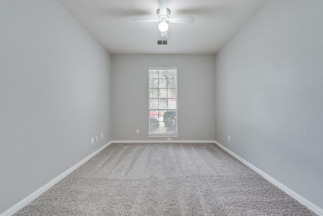 spare room featuring ceiling fan and carpet