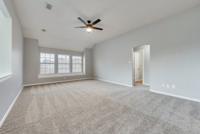 unfurnished room with vaulted ceiling, ceiling fan, and light colored carpet