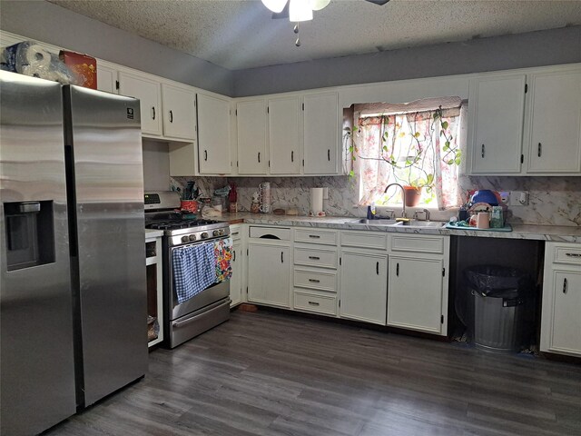 kitchen featuring tasteful backsplash, stainless steel appliances, ceiling fan, dark wood-type flooring, and white cabinets