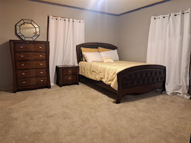 bedroom featuring light carpet, a textured ceiling, and ornamental molding