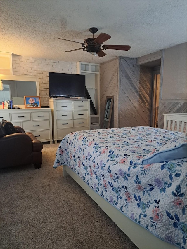 carpeted bedroom featuring a textured ceiling, ceiling fan, and wood walls