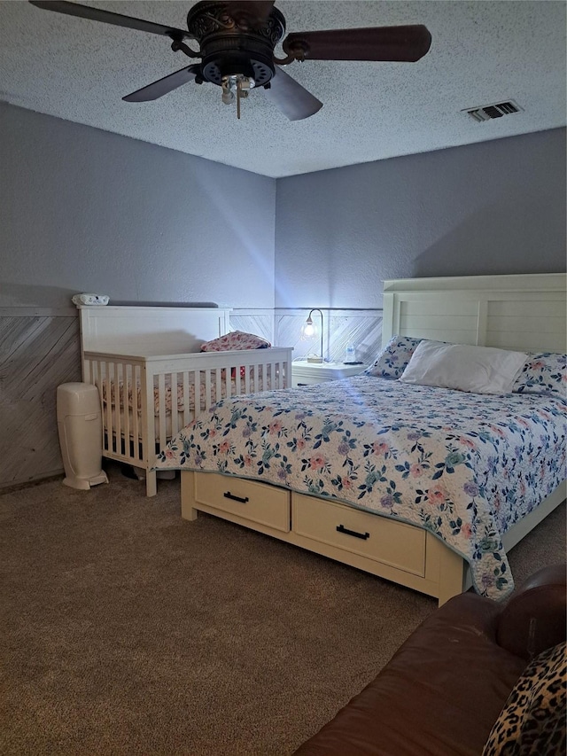 unfurnished bedroom featuring ceiling fan, carpet, and a textured ceiling