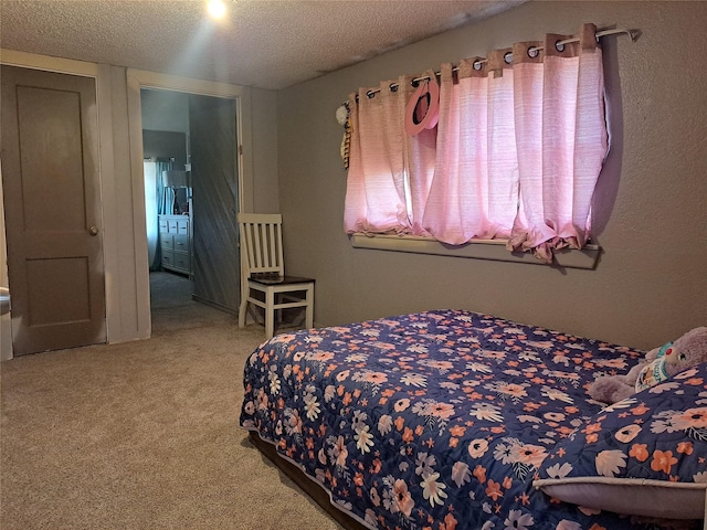 bedroom with carpet floors and a textured ceiling