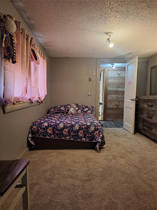 carpeted bedroom featuring a textured ceiling