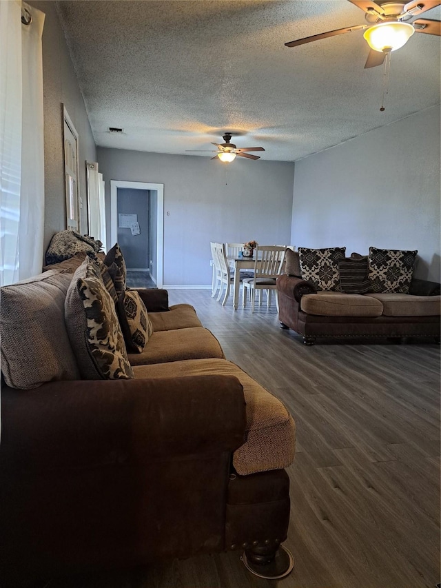 living room with a textured ceiling and hardwood / wood-style flooring