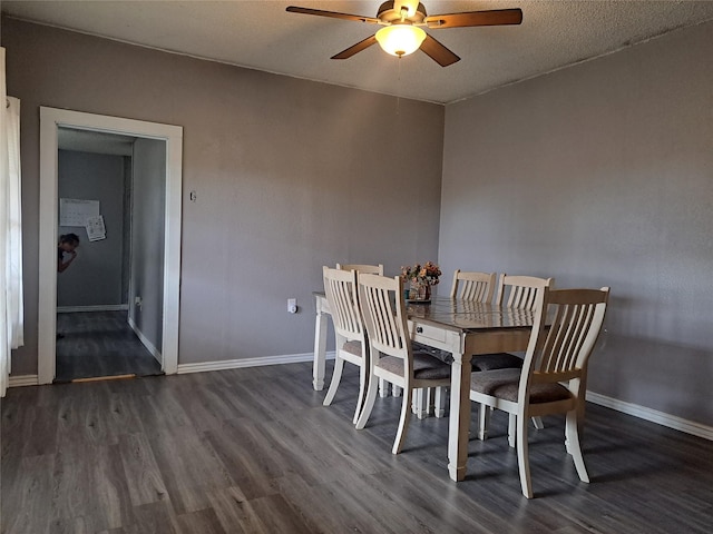 dining space featuring a textured ceiling, dark hardwood / wood-style flooring, and ceiling fan