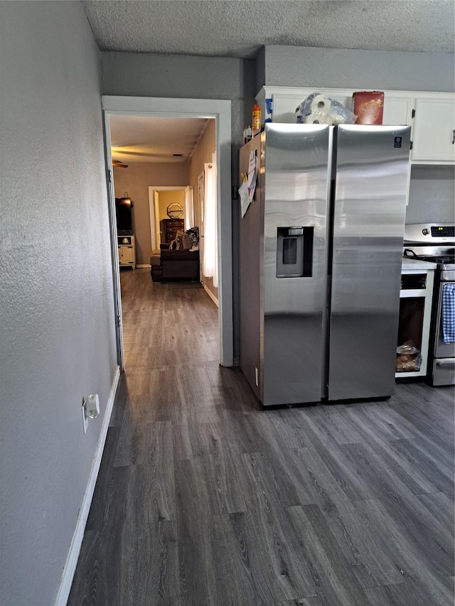 kitchen with white cabinetry, stainless steel appliances, and dark wood-type flooring