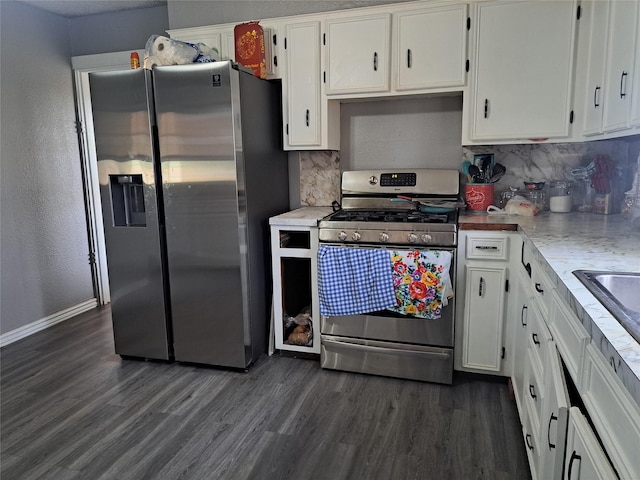 kitchen featuring backsplash, dark hardwood / wood-style flooring, white cabinetry, and stainless steel appliances