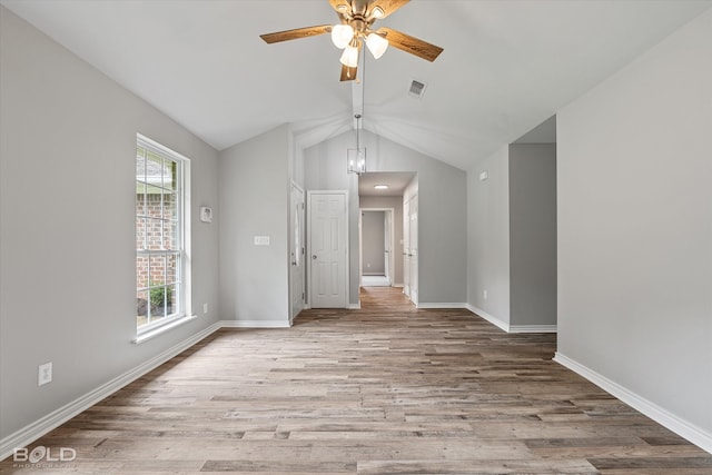 spare room with lofted ceiling, a healthy amount of sunlight, ceiling fan, and light hardwood / wood-style flooring