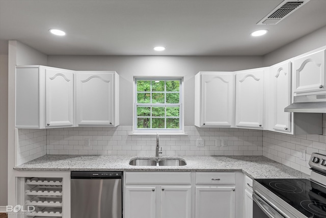 kitchen featuring appliances with stainless steel finishes, exhaust hood, and white cabinetry