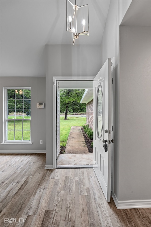 entryway featuring a chandelier and light hardwood / wood-style floors