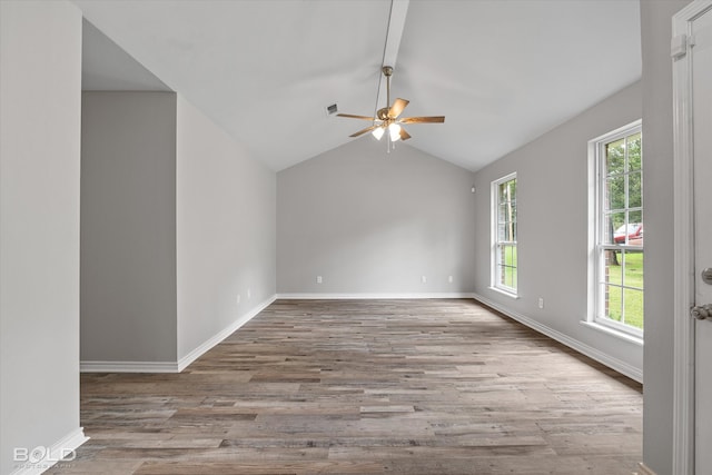 empty room with light wood-type flooring, ceiling fan, and lofted ceiling with beams