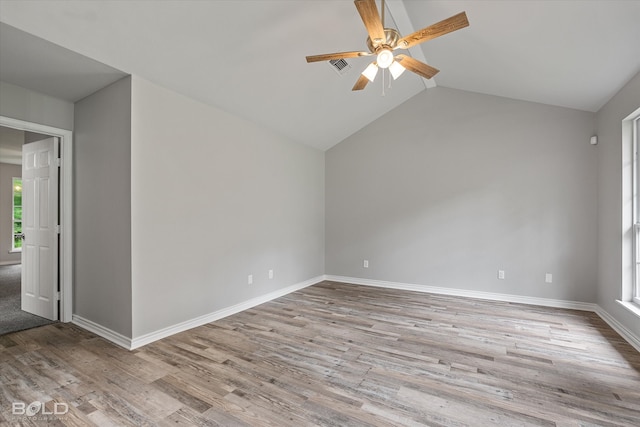 unfurnished room with light wood-type flooring, lofted ceiling, and ceiling fan