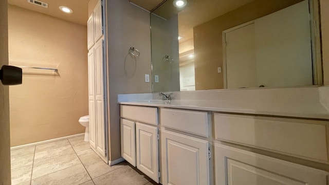 bathroom with tile patterned floors, vanity, and toilet