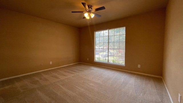 spare room with carpet flooring and ceiling fan