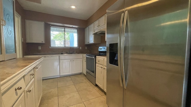 kitchen featuring sink, appliances with stainless steel finishes, light tile patterned flooring, white cabinetry, and extractor fan