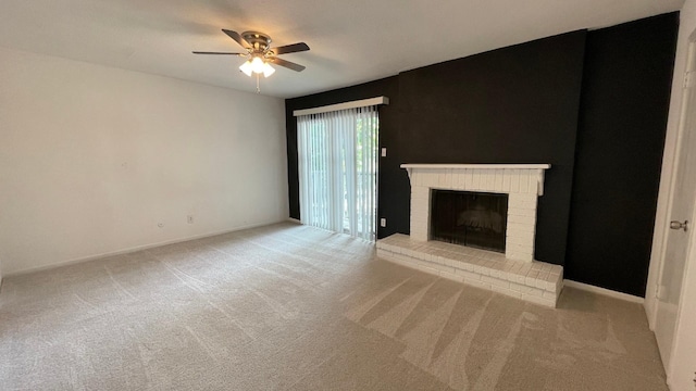 unfurnished living room featuring ceiling fan, light colored carpet, and a brick fireplace