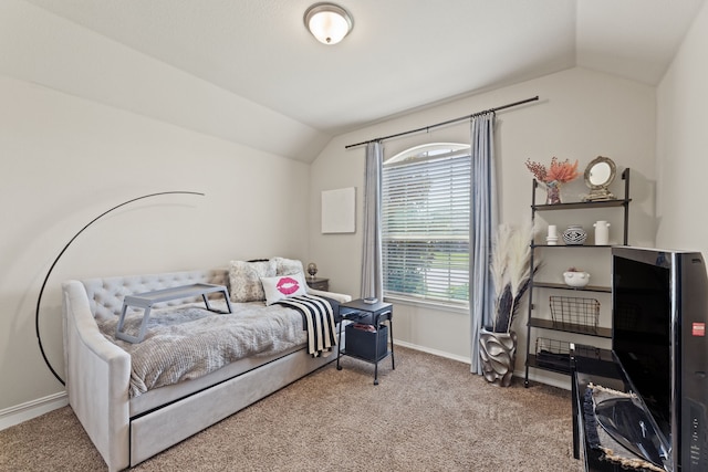 bedroom with lofted ceiling and light colored carpet