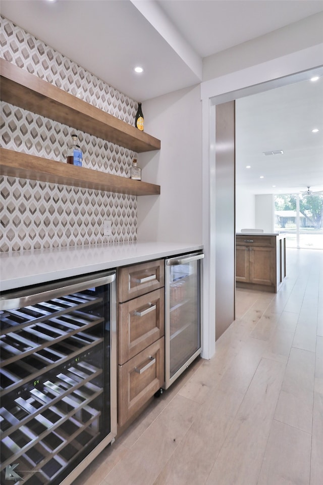 bar with decorative backsplash and beverage cooler