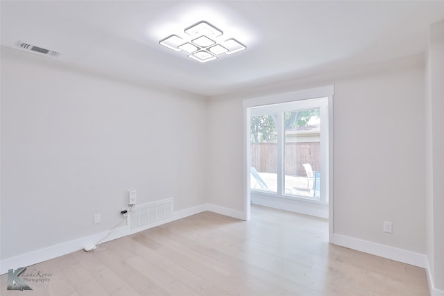 spare room featuring light hardwood / wood-style floors