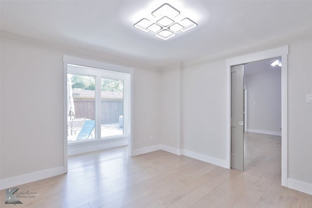 unfurnished room with light wood-type flooring