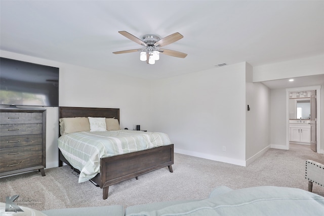 carpeted bedroom with sink, ensuite bath, and ceiling fan