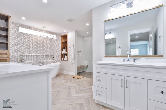 bathroom with vanity, parquet floors, and a bathing tub