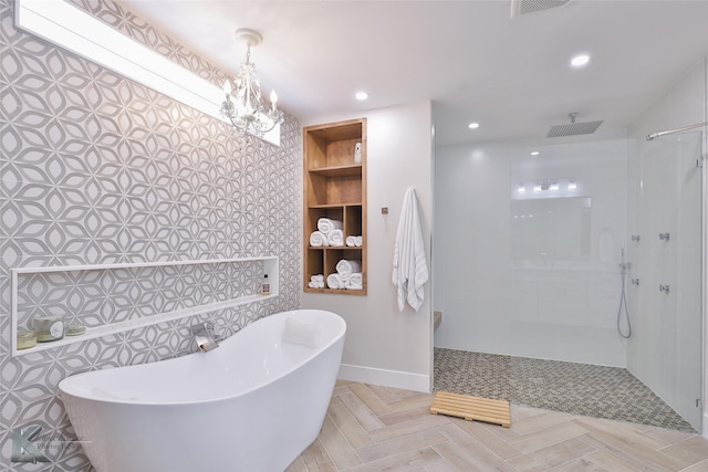 bathroom featuring shower with separate bathtub and a notable chandelier