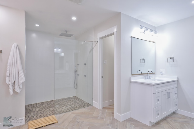 bathroom featuring parquet floors, vanity, and a tile shower