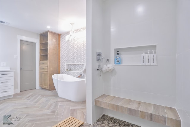 bathroom with a tub and parquet floors